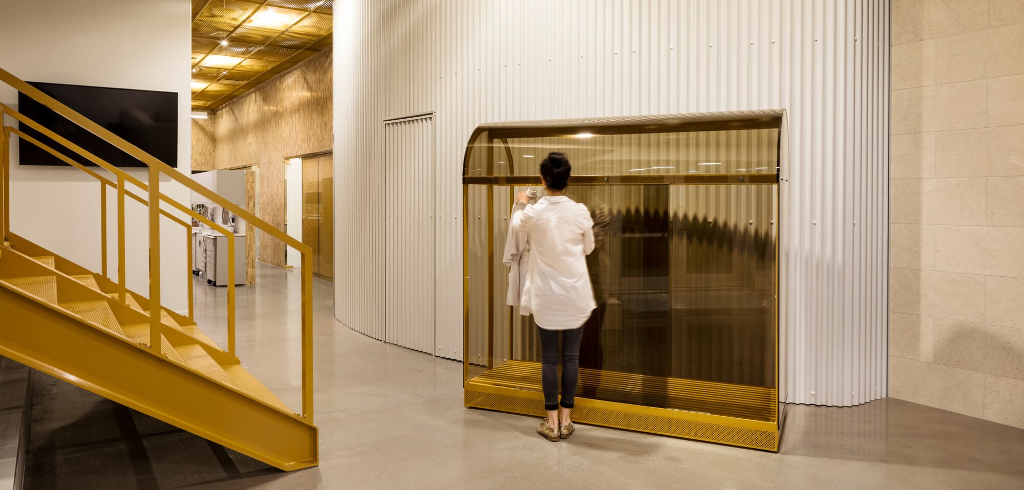 Mobile cabinet stands beside a white curved wall at Go Orthodontistes office, designed by Natasha Thorpe