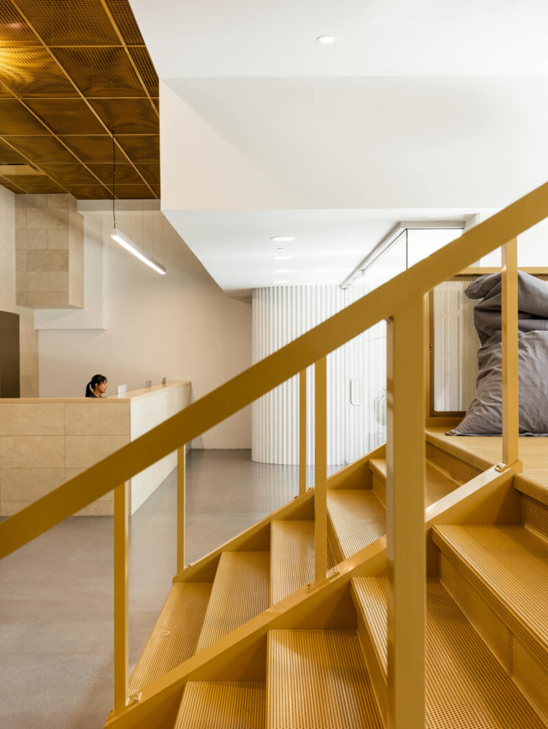 Reception and golden staircase at Go Orthodontistes office, designed by Natasha Thorpe