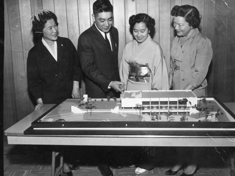 Raymond Moriyama and others with architectural model, black and white