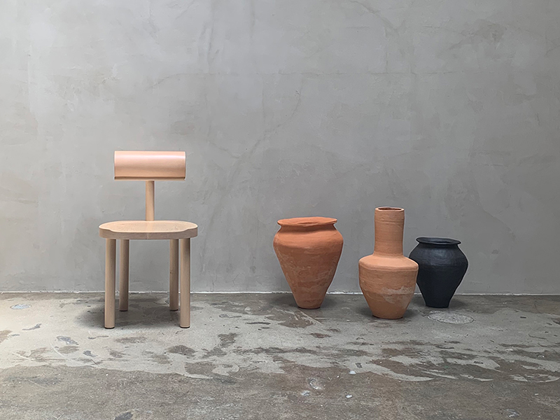 Chair and vases on concrete background