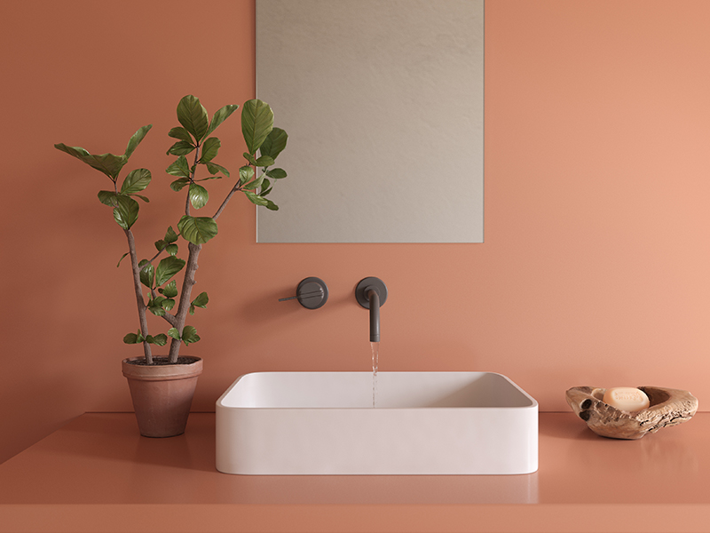 Red Silestone countertop with white sink and black faucet, with plant in a terracotta pot