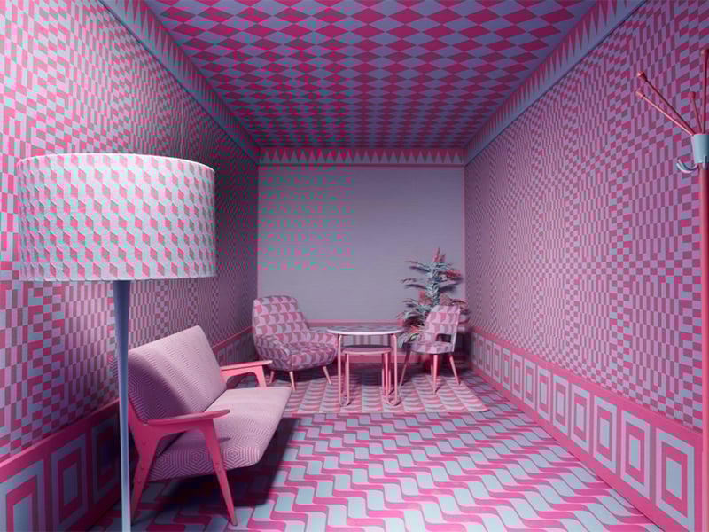 Room containing sofa, two chairs, side table, floor lamp, and coat rack, all covered in a pink and grey pattern