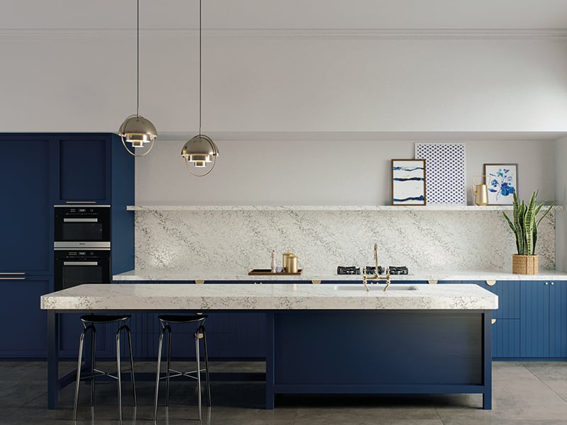 Kitchen with blue island and cabinets, and white Caesarstone countertop and backsplash