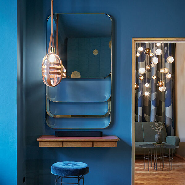 Blue room with stool and rectangular mirror at BOMMA Atelier