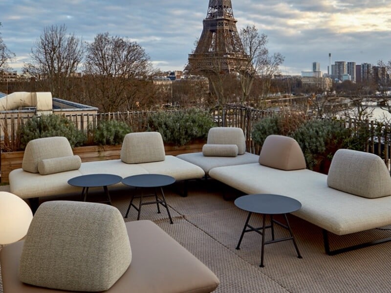ligne roset murtoli outdoor sofas in beige with stools and eiffel tower in the background