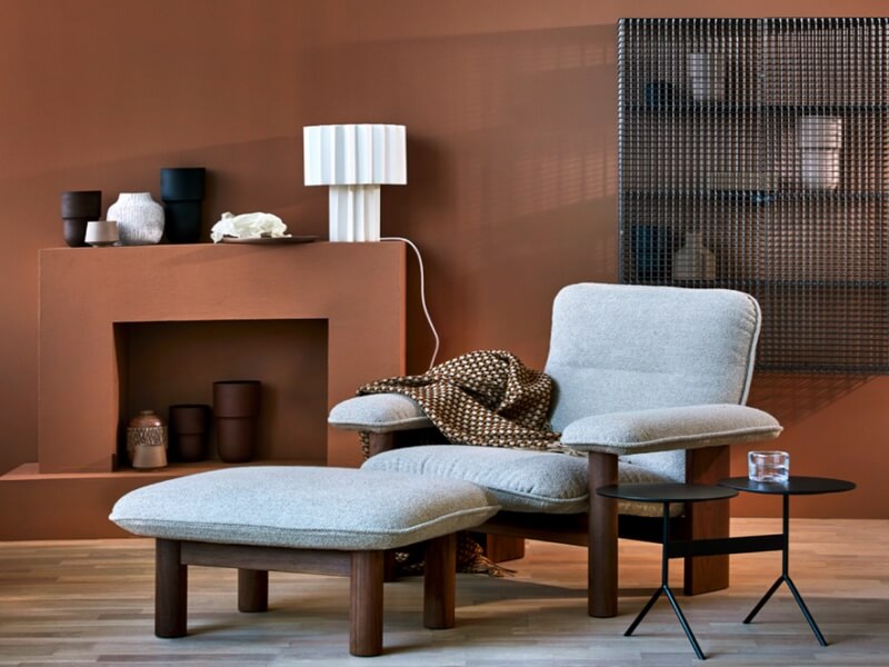Oslo Design Fair 2022 Interior Design living rooom set with maroon walls and white sofa chair