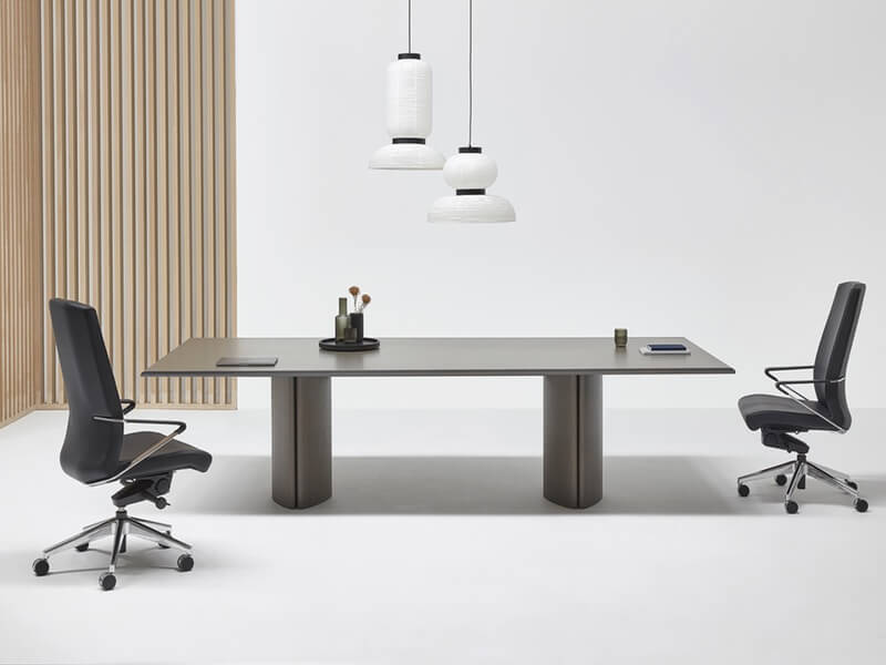 Rowan Collection Office tables and desks featuring large meeting room wood table with two desk chairs and light wood accent background