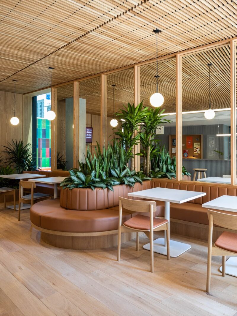 Zendesk Montreal Office design by Menard Dworkind and MHA Design featuring a cafe with curved leather benches and white oak seats.