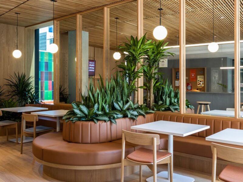 Zendesk Montreal Office design by Menard Dworkind and MHA Design featuring a cafe with curved leather benches and white oak seats.