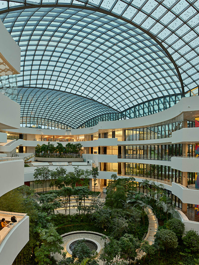 A view of the Albert Einstein Center atrium from the middle levels, showing greenery below the Moshe Safdie-designed canopy