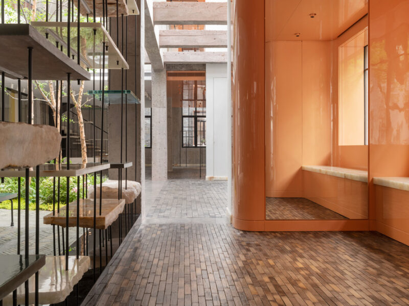 view of Shanghai store from low vantage point, showing the paving stone floor in context of display walls and outdoor courtyard greenery