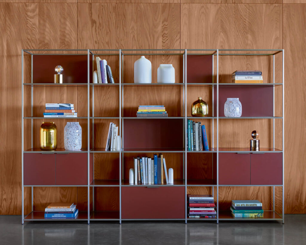 Red shelving unit styled with books and decorative items