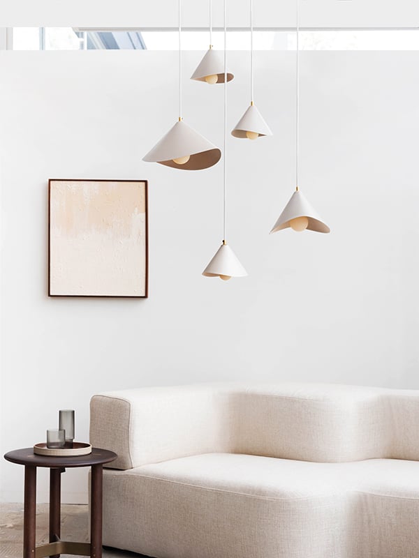 Lotus pendant lamps by Luminaire Authentik above a cream sofa