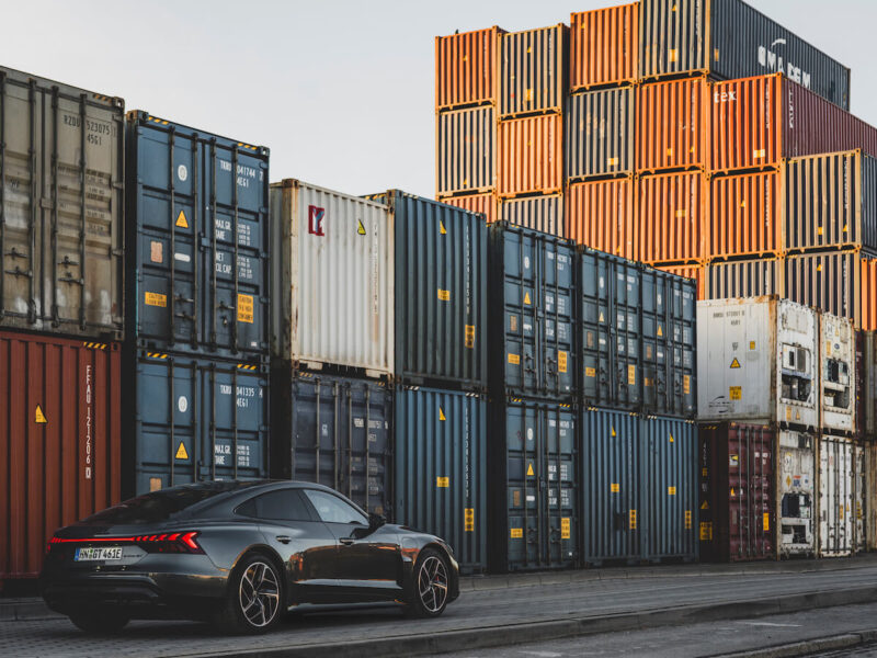 Azure Audi e-tron GT 2 EV set against shipping containers