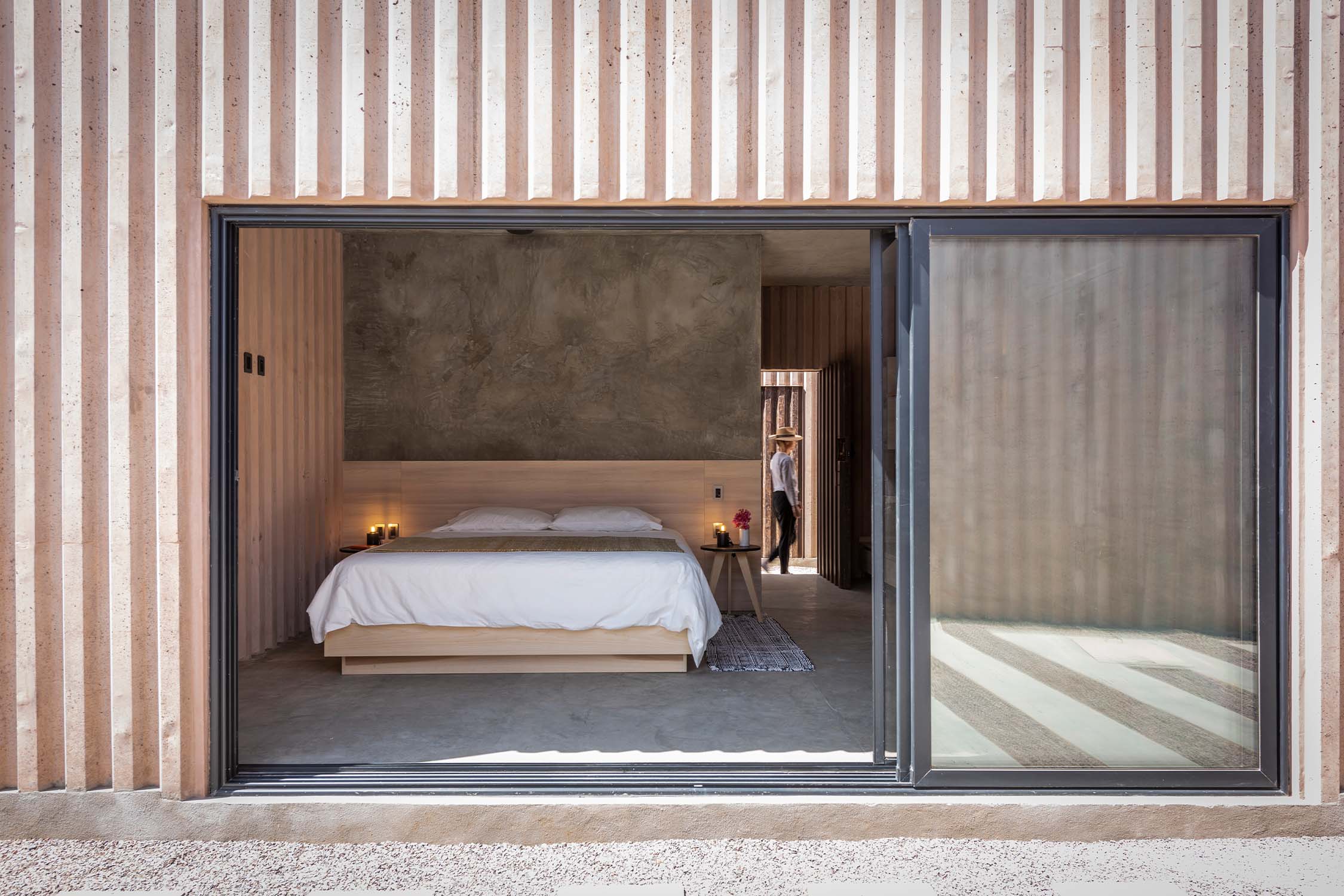 View of large sliding window that provides entry to the bedroom interior