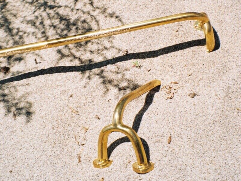 Fauna Gold cabinet door handles on sandy beach on film