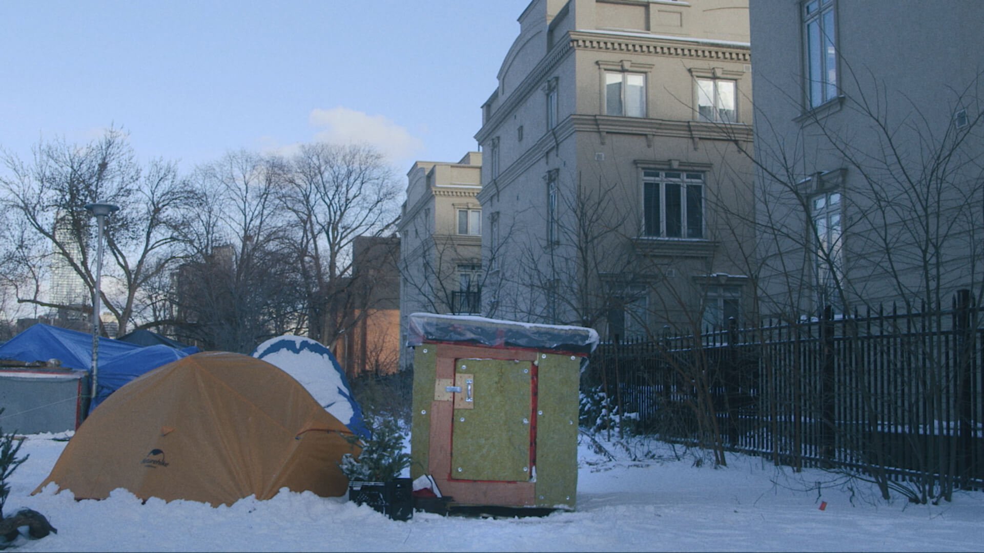 A still from Someone Lives Here, showing one of the tiny shelters in an urban encampment