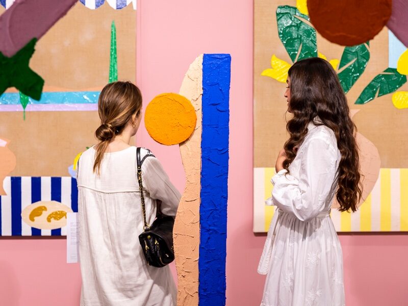 VOLTA Art Fair two women looking at colourful textured geometric art exhibition piece