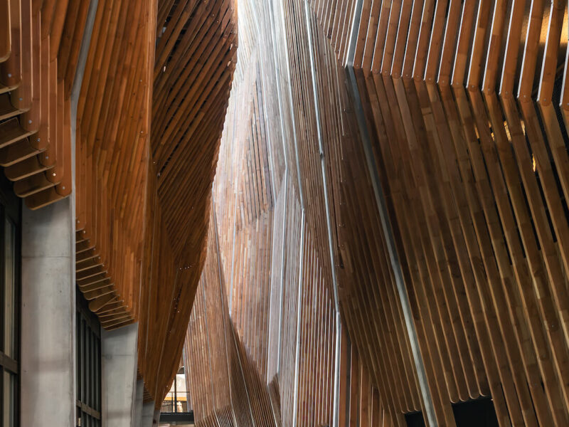 Inside the narrow, wood-clad public passageway in the building's courtyard
