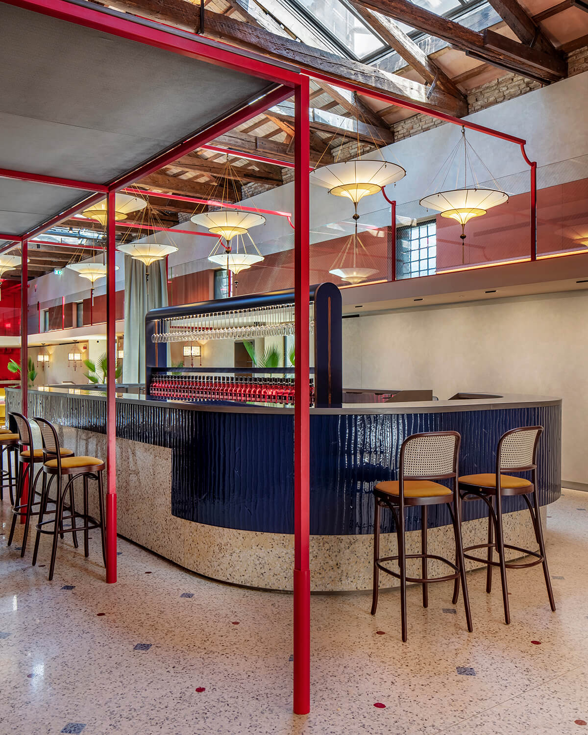 Fortuny lamps and a blue fused-glass counter reflect Venice’s craft tradition.
