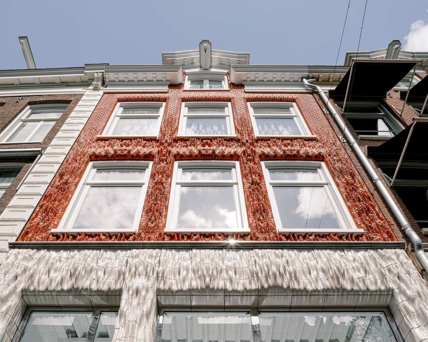 In Amsterdam, the 3D-printed facade of Ceramic House by Studio RAP was inspired by knitwear and ceramics.