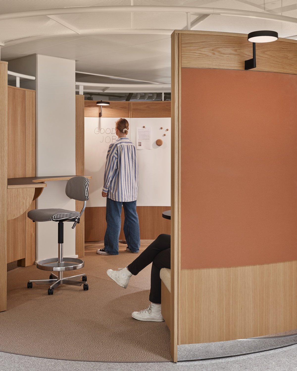 Collaboration area with curved wood walls and white board