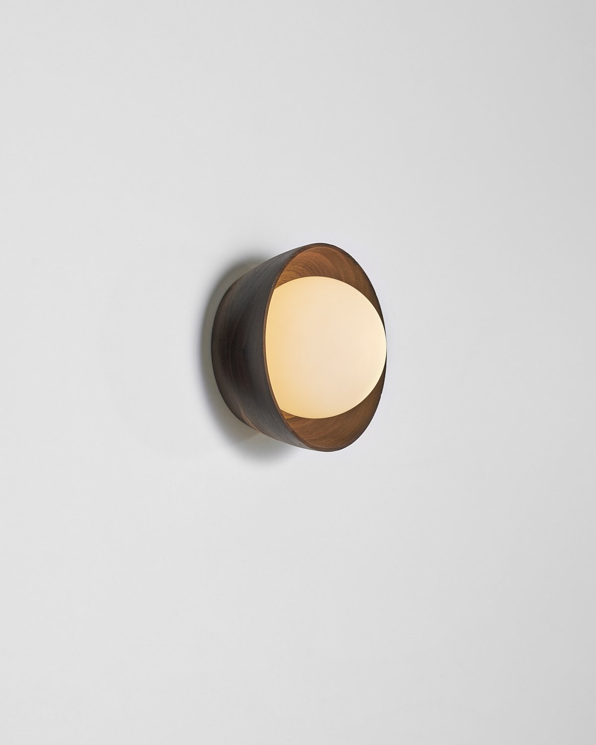 The Berm sconce by Toronto studio hollis+morris showcases the wood bowl's unique grain