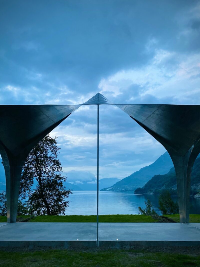 A view of the Hardangerfjord in Norway looking through the steel arches of a roadside stop structure by Code Arkitektur.
