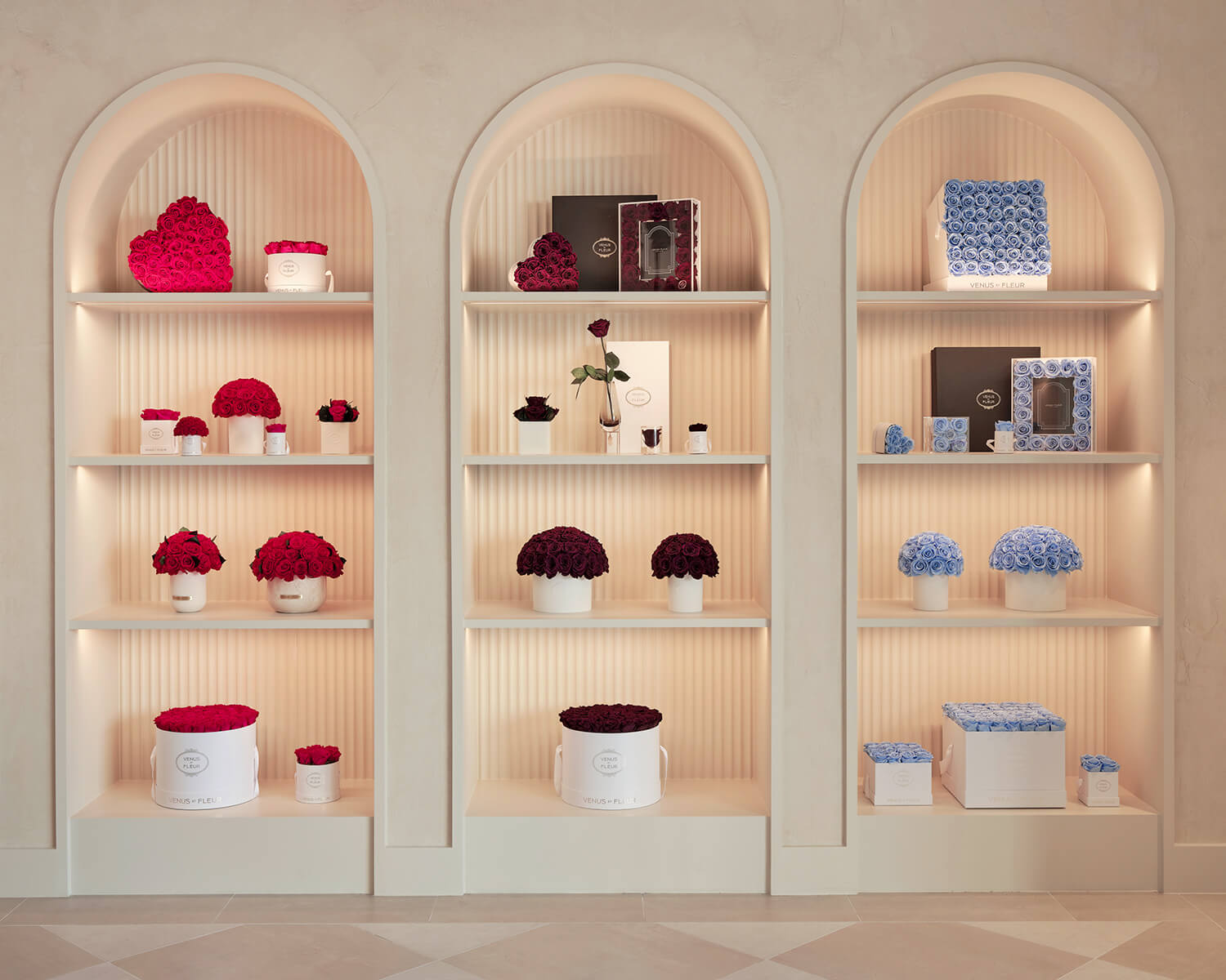 Bouquets of roses displayed in arched recessed shelving