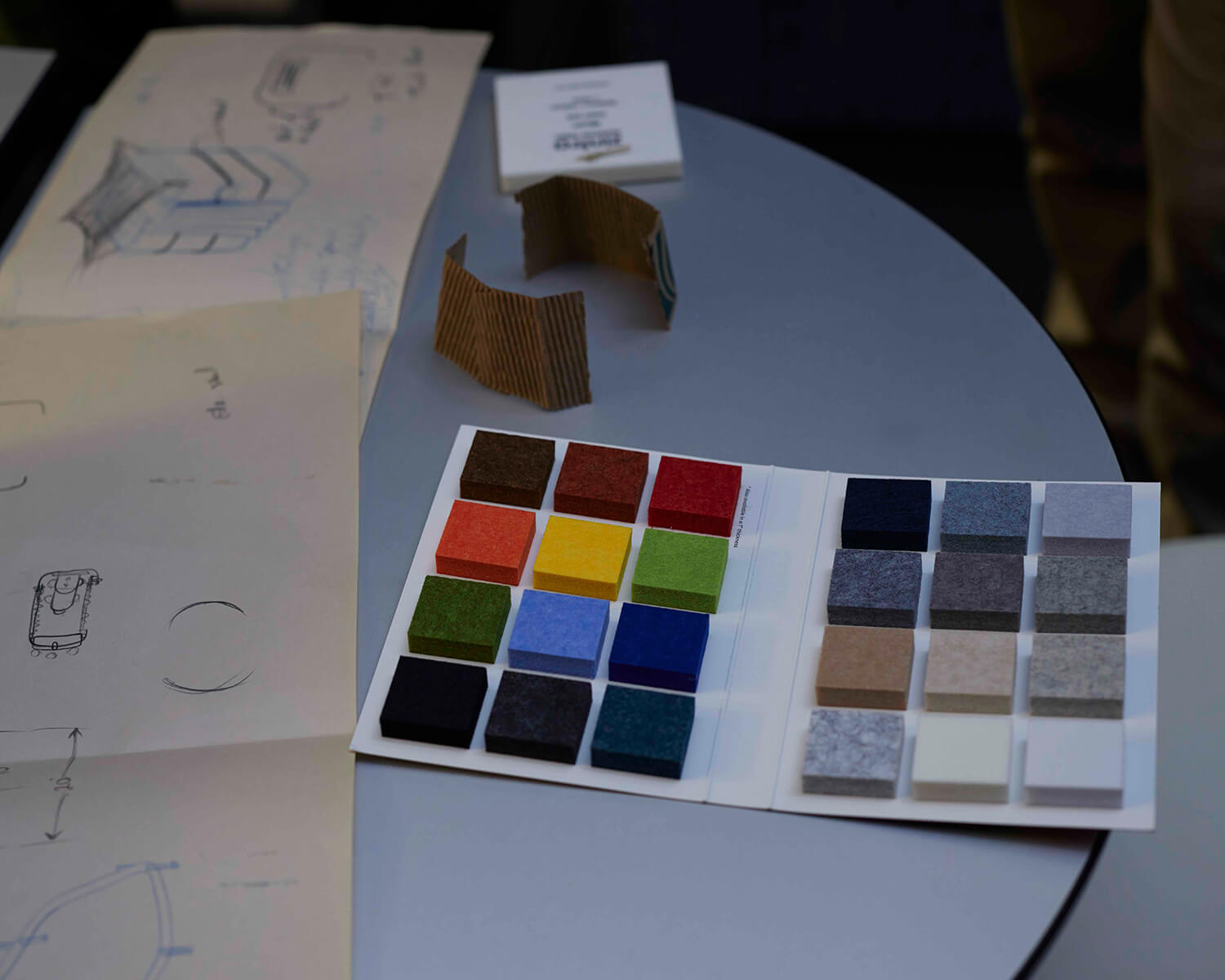 Colour samples and sketches on a round table