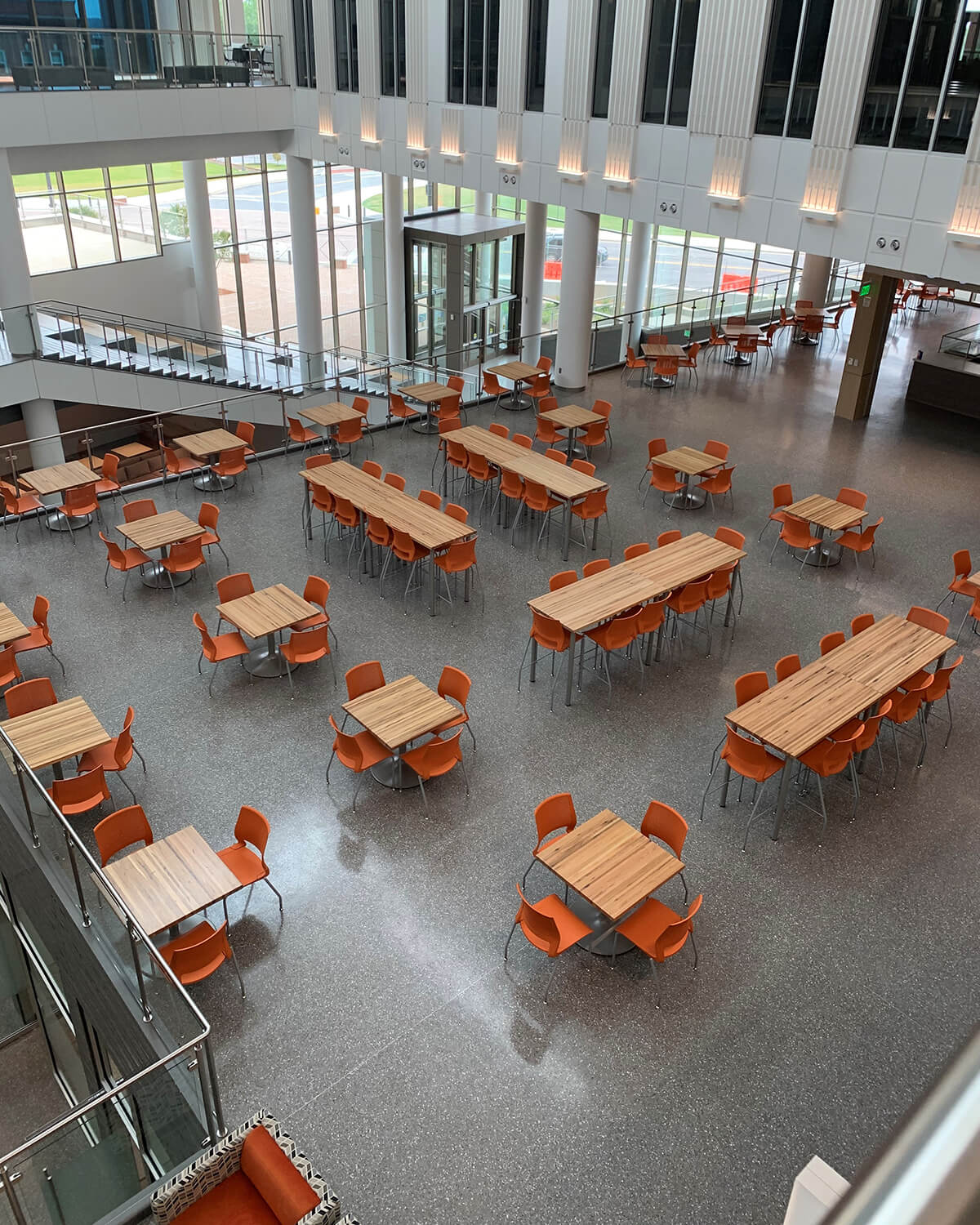 Custom café tables with reclaimed wood tops, custom designed for Clemson University by contract furniture manufacturer KI
