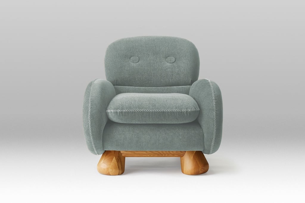 A modern cottagecore chair featuring rounded cushions and bulbous legs.