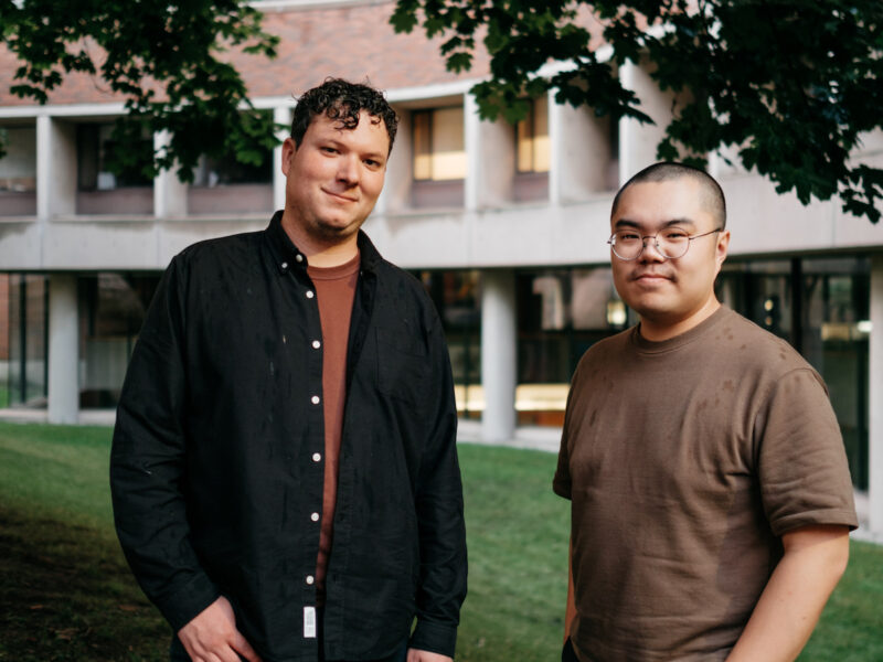 Make Good Projects. Joel Leon and Kurtis Chen pose in front of an apartment building.