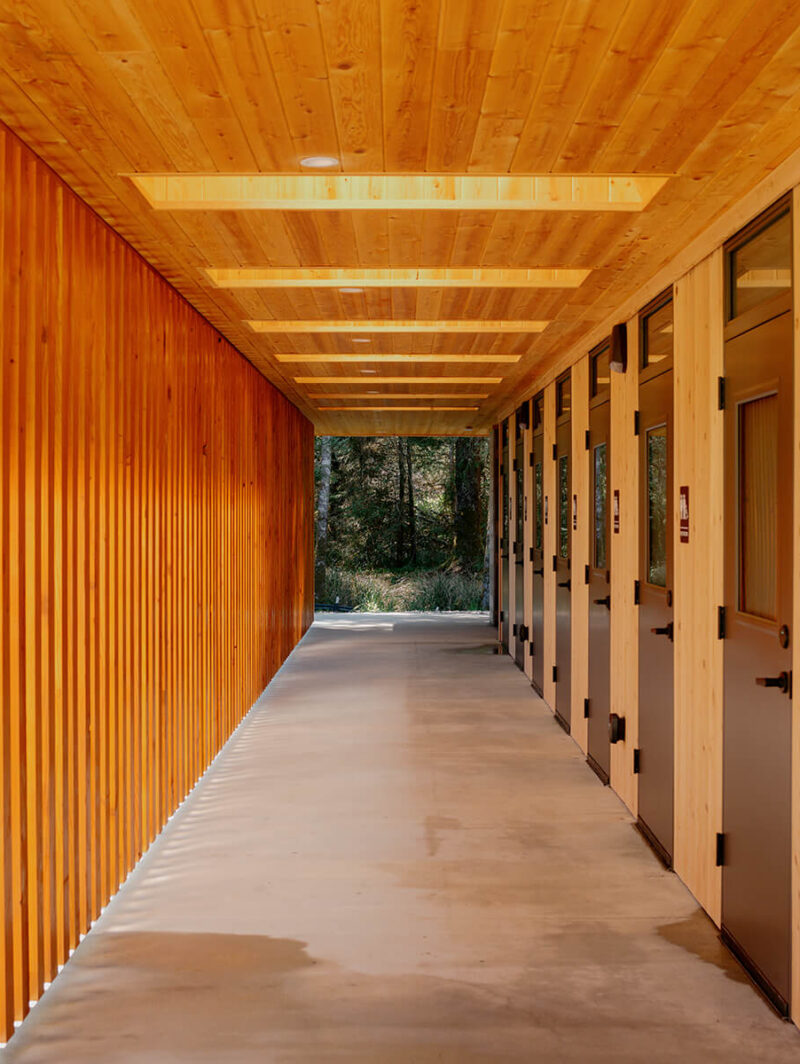 An exposed wood structure lends the wash house a sense of warmth and complements the serene atmosphere of the nearby Ofuro Spa.