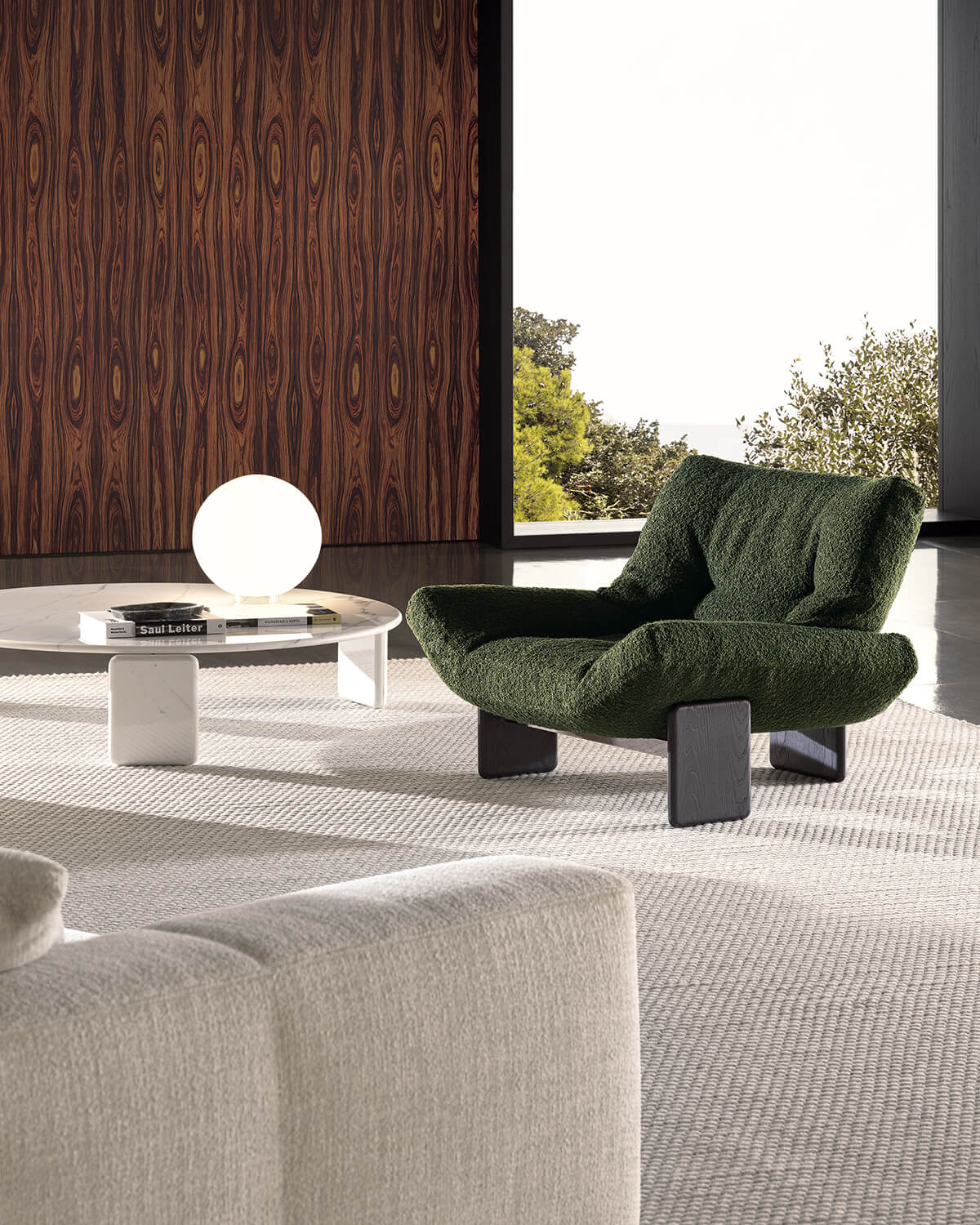 The Emmi armchair by Hannes Peer for Minotti rests on a trio of totemic legs.