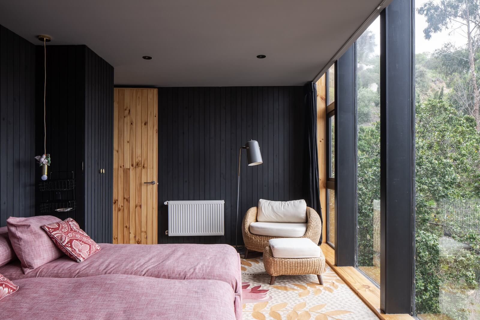 At Ignacio Correa's house in Chile, the primary bedroom’s wall of glass is anchored by a wide oiled-pinewood border that, as Correa says, makes you understand that “you’re in a constructed place.”