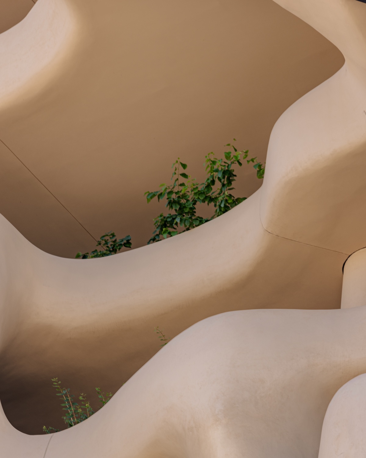 A closeup of curving plaster balconies.