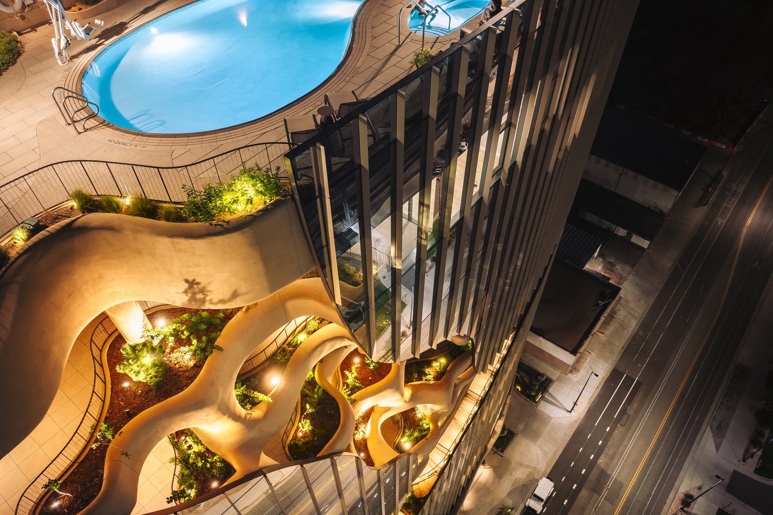 Looking down from the rooftop pool of One River North in Denver to the curving balconies and walkways below.