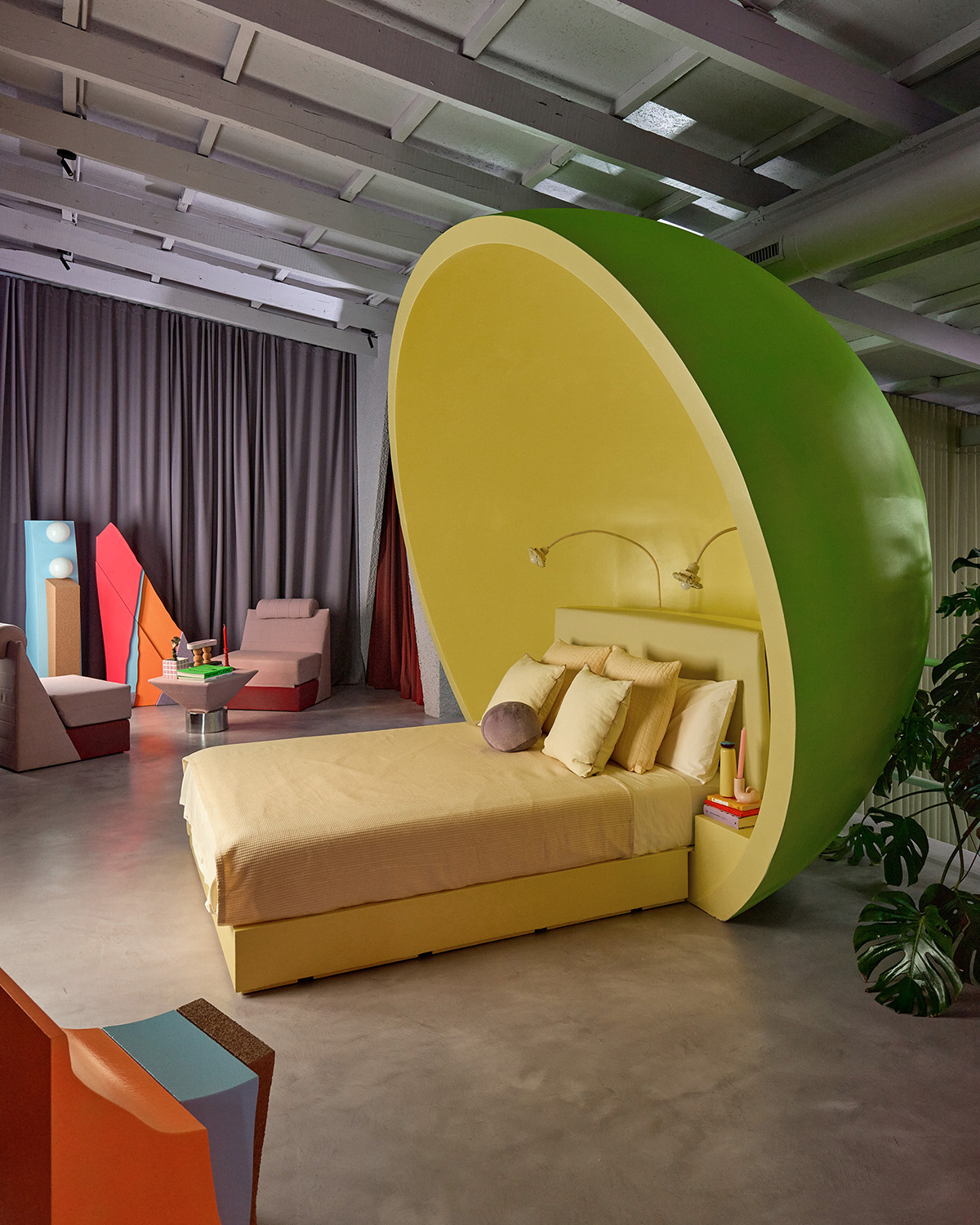 Exemplifying Masquespacio’s signature blend of maximalism and whimsy, the upper-level bedroom combines vivid tones of lime green and acid yellow with robust geometric forms.