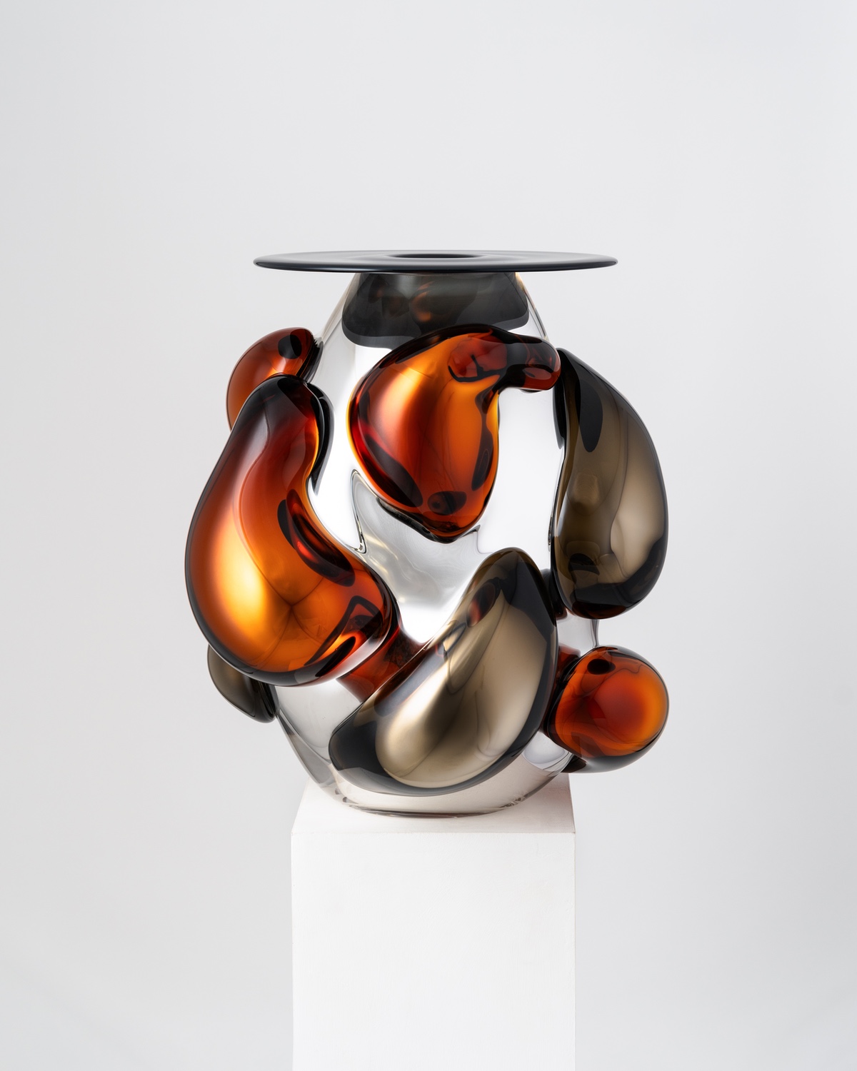 A glass vase with molten orange and grey forms attached to it — one of the best designs of Design Miami and Alcova Miami 2024.