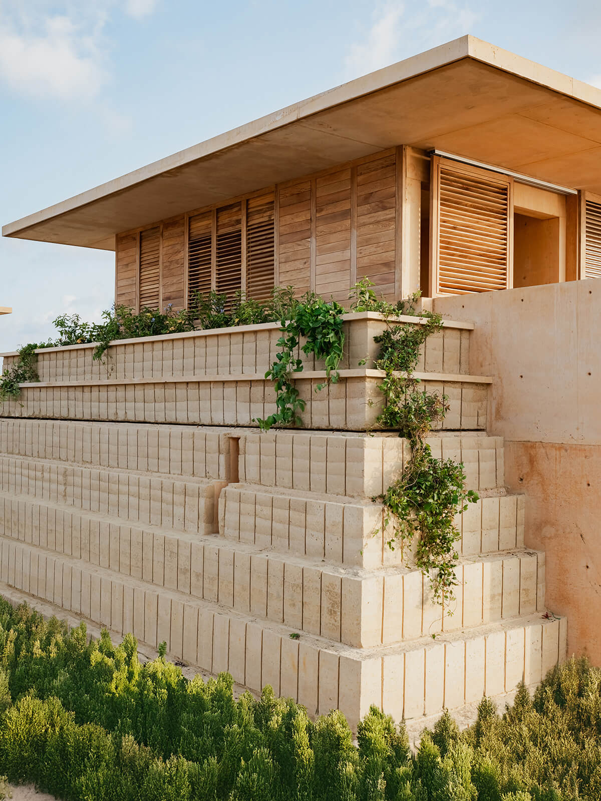 Chosen for their thermal qualities and local availability, the rammed earth blocks “will age beautifully and naturally and let the pyramids evolve with the landscape over time,” says architect Natalia Badia.
