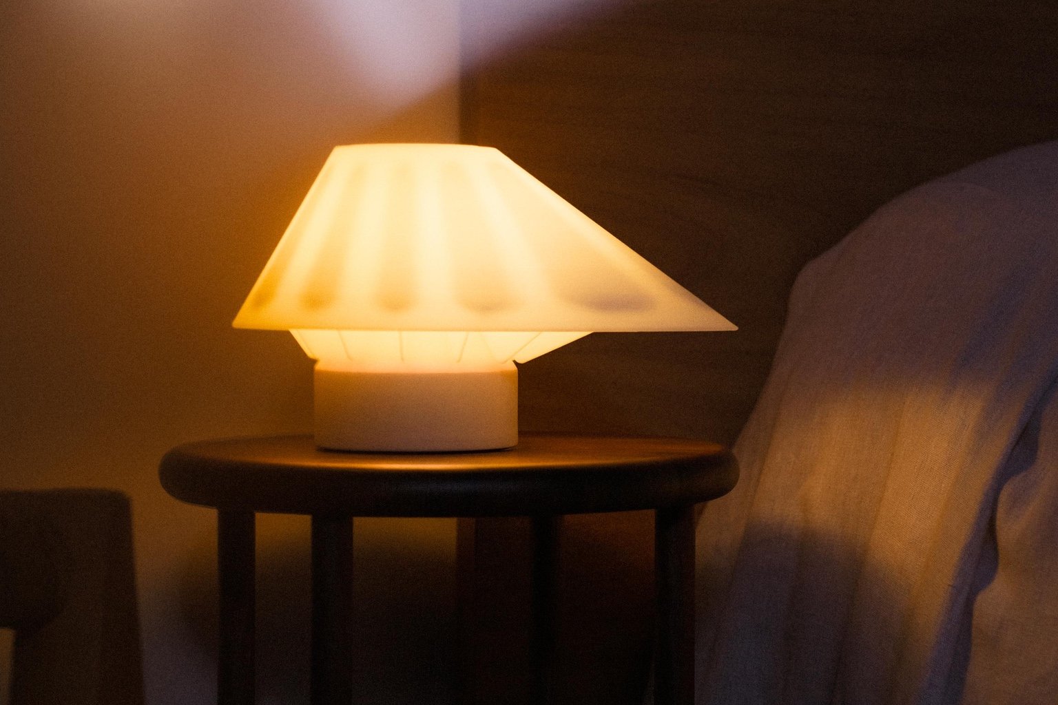 A table lamp with a triangular shade.