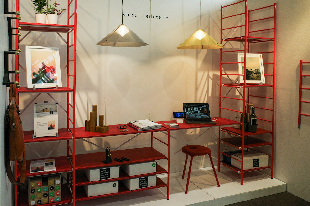 A cherry red modular shelving unit by Object Interface for IDS 2025, showcasing a collection of hardware pieces, plants and frames.