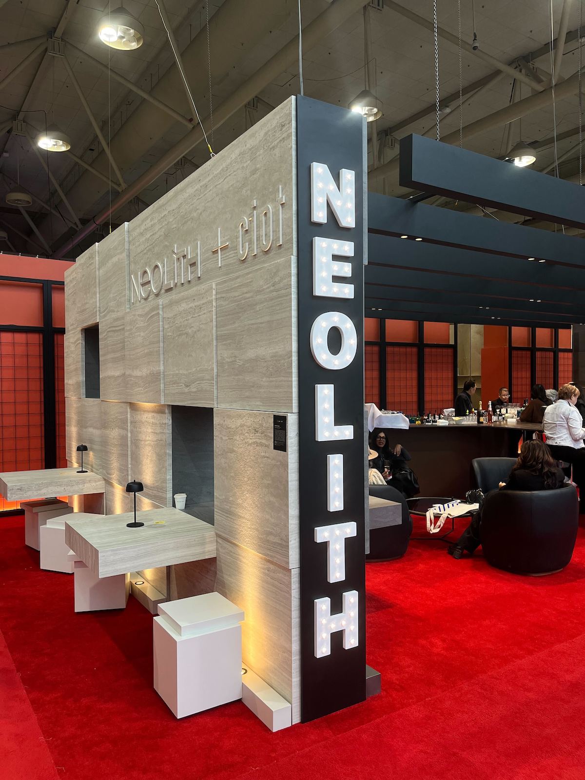 A soft grey and black reimagining of the hotel bar by Yabu Pushelberg in collaboration with Neolith at IDS 2025.