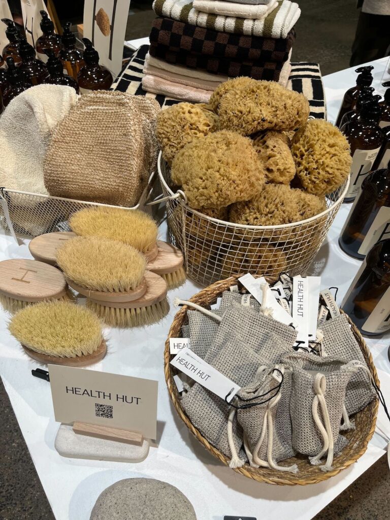 A selection of dry brushes, loofahs, body lotions and soaps by Health Hut at IDS 2025.