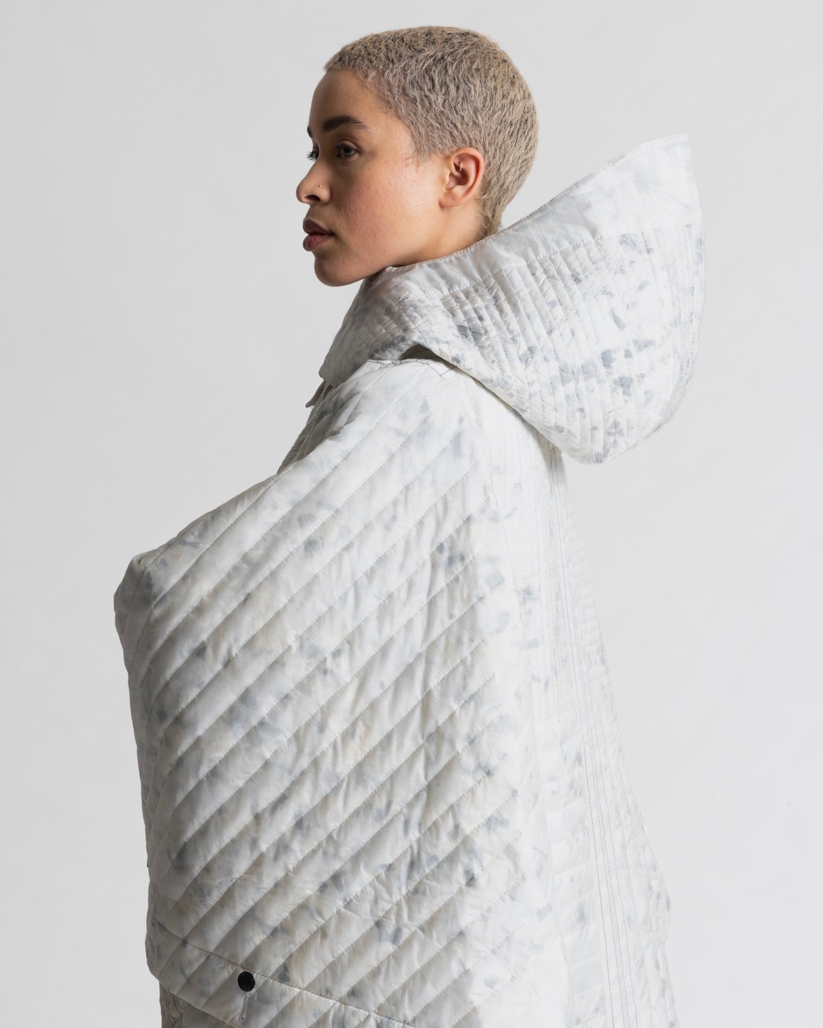 A side view of the blanket suit showing the back hood.