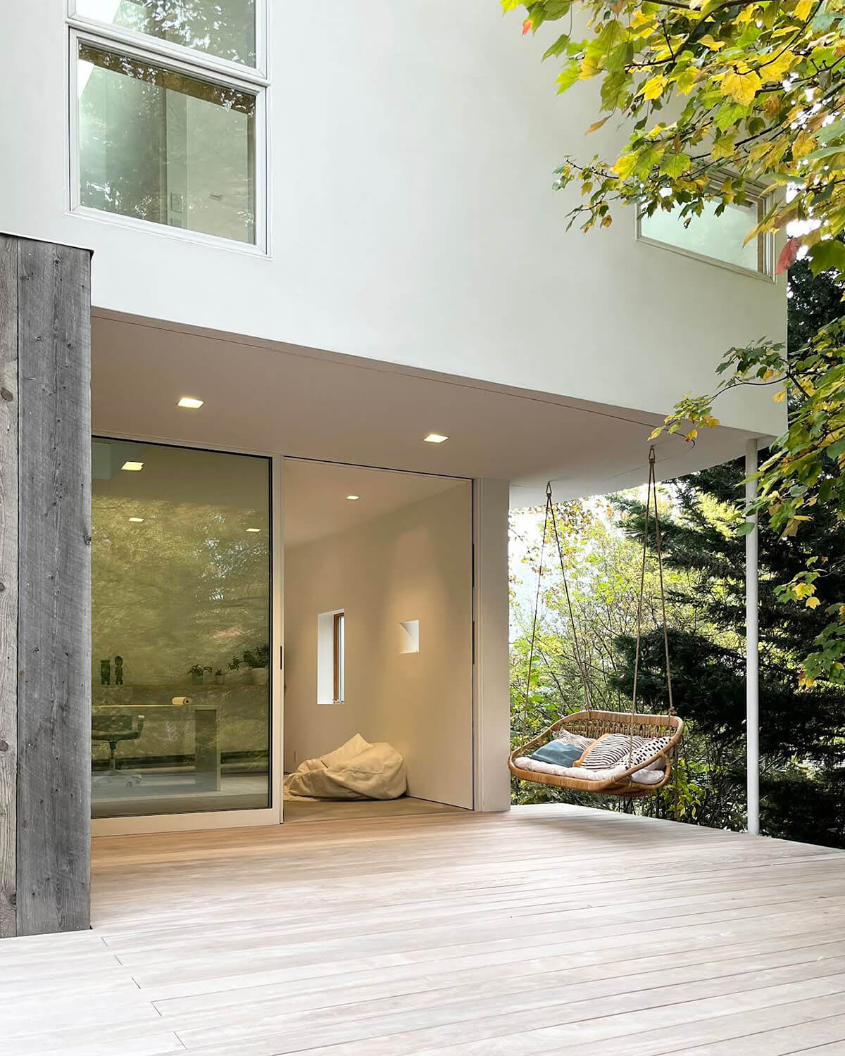Around back, a portion of the addition’s second storey cantilevers above a terrace, creating the perfect nook for a swing.