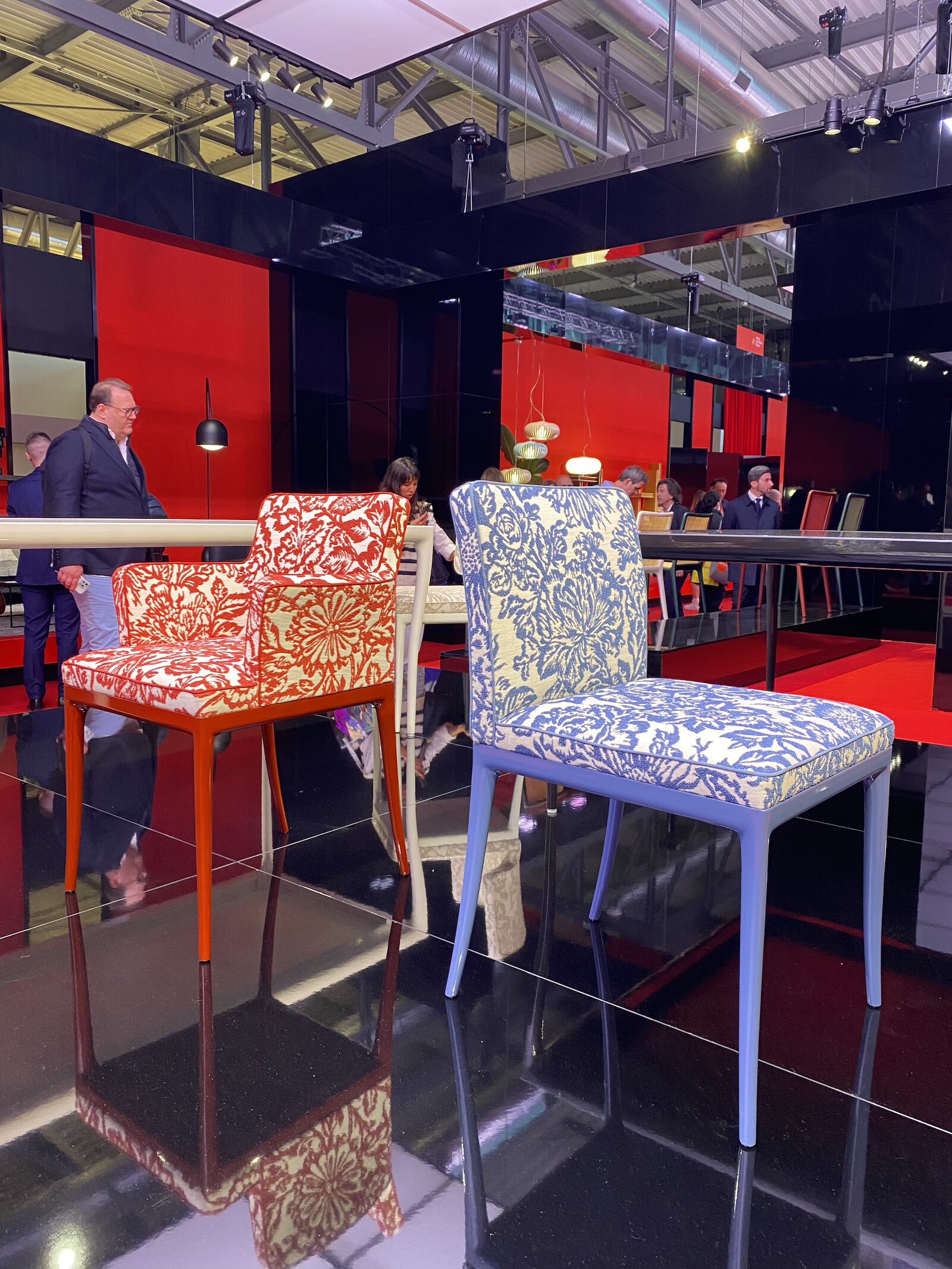 Two floral-patterned chairs from Kartell's booth at Salone del Mobile 2025.