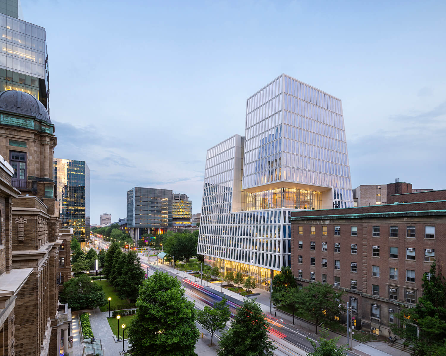 Rising near the corner of University and College, the Schwartz Reisman Innovation Campus boasts a canted building envelope that is carved away to reveal the structure's inner workings.