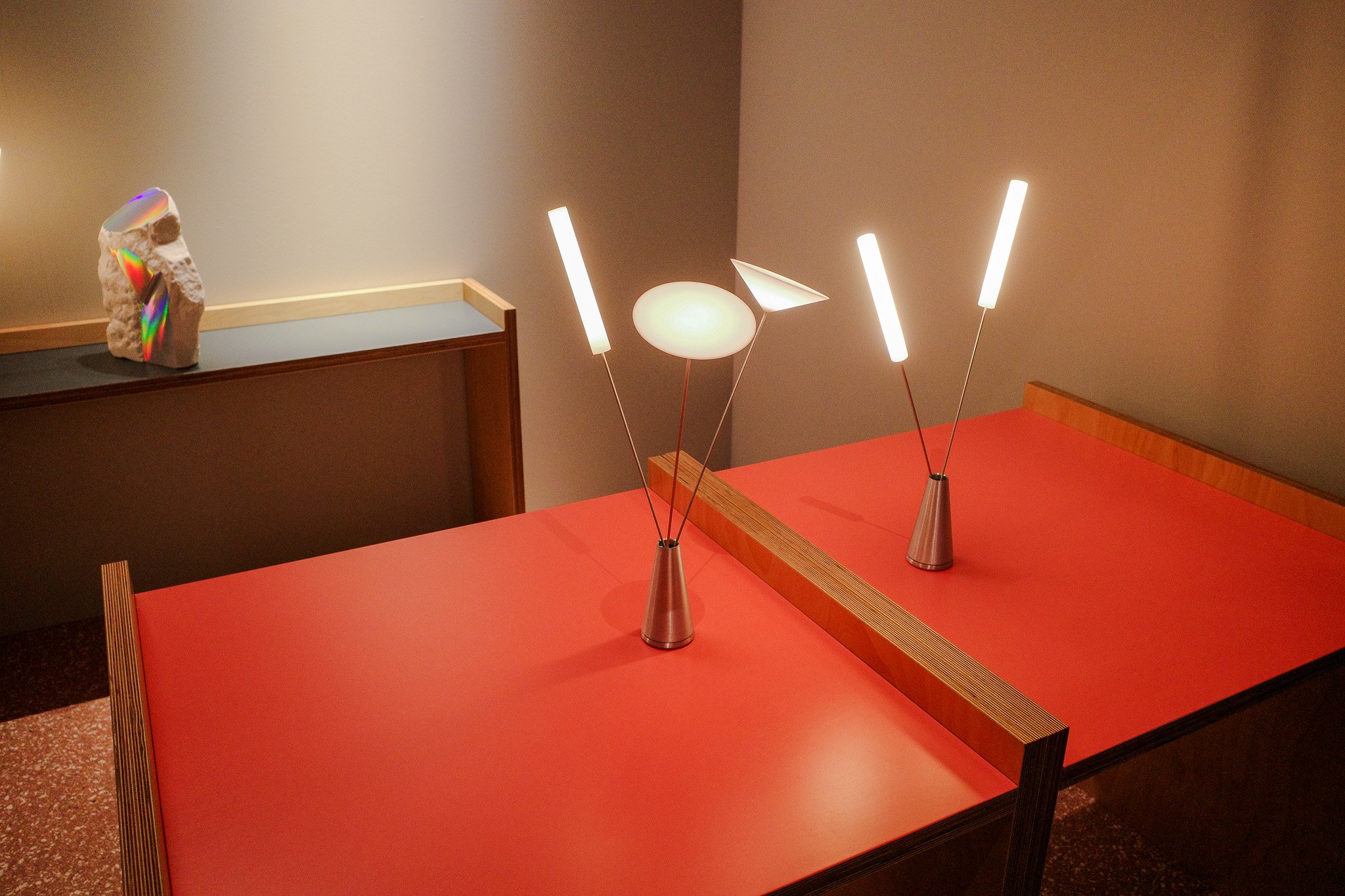 A table lamp that resembles a vase with a series of three glowing stems like flowers at Euroluce during Salone del Mobile 2025.